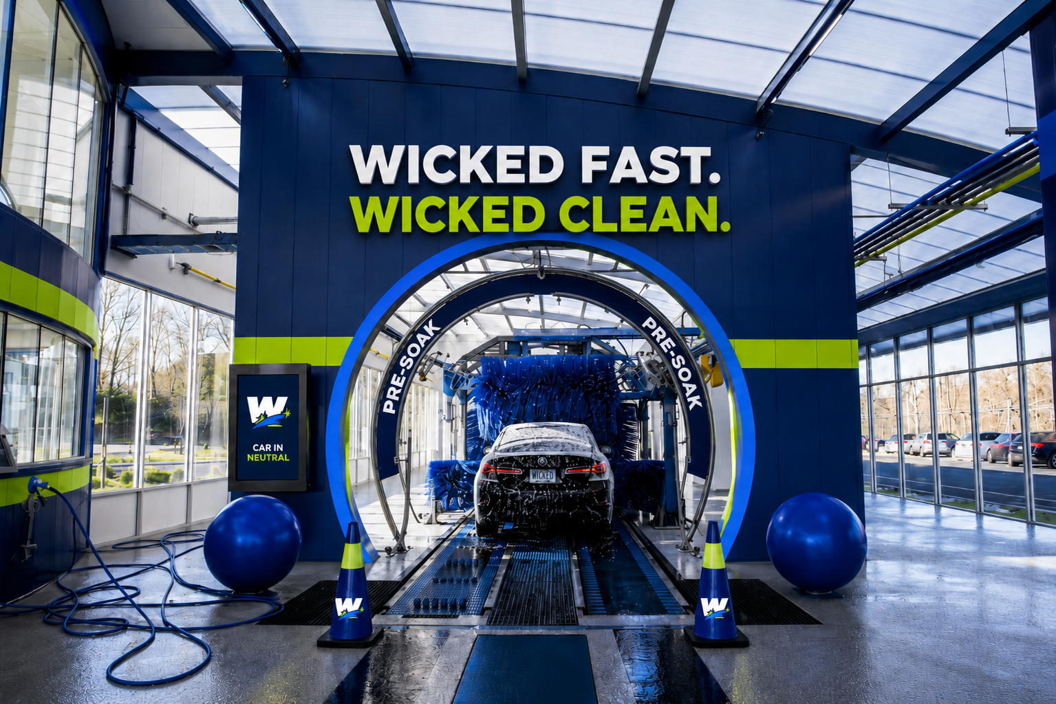 Wicked Clean tunnel entrance with bold W branding and electric blue glow.